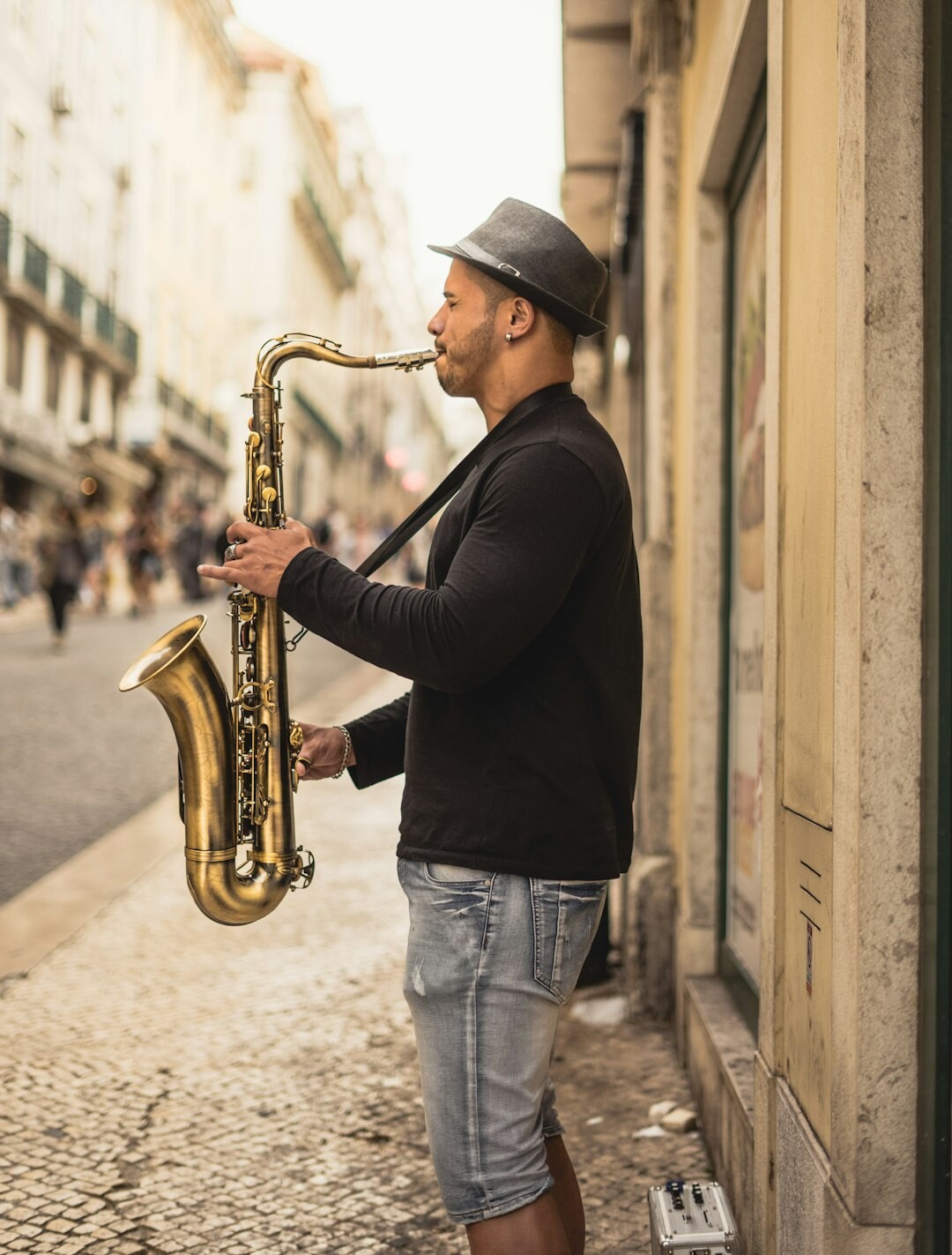 Portrait of a Black European jazz musician holding a saxophone